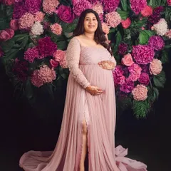 Our floral wall is a favorite for a reason. Here, the mom-to-be glows in a beautiful dusty rose gown, creating a portrait that is both vibrant and incredibly elegant.