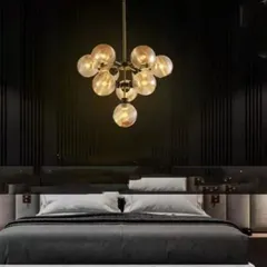 This gold globe chandelier adds a touch of luxury and warmth to this modern bedroom. The cluster of amber glass globes provides a soft, ambient light that is perfect for creating a relaxing and sophisticated atmosphere.