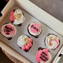 A pretty set of pink and white cupcakes for a bridal shower. I used gold leaf and custom toppers with the wedding date and a "bride to be" message.