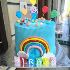 You can't escape the melon. This bright and cheerful Cocomelon cake is perfect for a toddler's birthday, featuring JJ, a big rainbow, and colorful letter blocks spelling out the birthday girl's name.