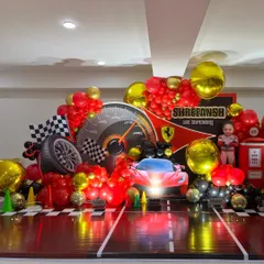 A centered view of the Ferrari stage, showing the speedometer backdrop and 3D car prop with working headlights.