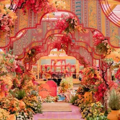 For the couple that loves color and artistry, this haldi entrance is a masterpiece. The layered, hand-painted arches and vibrant floral arrangements create an immersive experience that's both traditional and incredibly modern.