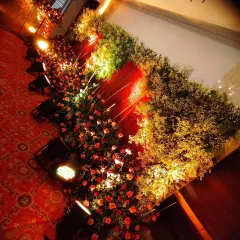 An example of how I use floor-level lighting to highlight dense floral arrangements. The warm uplighting on the red roses and baby's breath creates a dramatic and romantic effect.