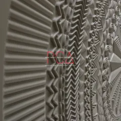 An angular, close-up view of the main door's CNC-milled patterns. This perspective emphasizes the three-dimensional quality and the complexity of the various geometric and organic motifs.
