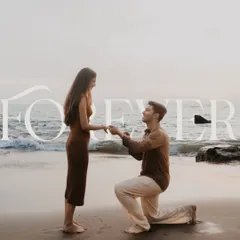 A classic proposal pose on the beach at dusk. This shot is the epitome of romance, capturing the promise of forever with the ocean as their witness.
