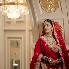 A moment of quiet elegance before the ceremony. Sona's traditional red bridal attire was paired with soft, glowing makeup and intricate jewelry, creating a timeless and royal portrait.
