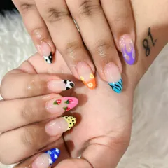 Can't decide on one design? Why not have them all? This mismatched set features a different hand-painted design on each nail, including cow print, flames, flowers, and strawberries.