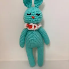 A sweet and sleepy 10-inch bunny, this amigurumi toy is made in a lovely teal color with a cute ruffled collar. It's perfect for cuddling.