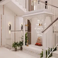 A side view of the Corian mandir, showcasing the detailed craftsmanship of the jali work and the hanging brass bells. The design is both traditional and timeless.