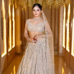 A full-length view showing how the dupatta draping and overall styling come together. The makeup is designed to shine even from a distance, with a focus on a radiant, highlighted complexion.