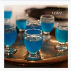 Welcome drinks set the tone for your event. I often serve these refreshing blue mocktail shots in elegant, small glasses as guests arrive. It's a simple touch that makes everyone feel immediately welcomed and ready to celebrate.