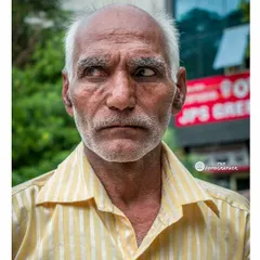 A slight turn of the head and a glance away can tell a different story. Here, the subject seems lost in thought, creating a more contemplative street portrait.