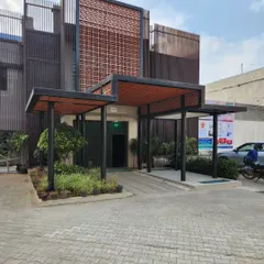 Another angle of the school entrance, showing how the black metal frame and terracotta elements create a warm yet contemporary look. The inclusion of small trees and planters brings an element of nature right to the front door.