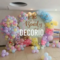 This "We Can Bearly Wait" baby shower setup shows how I use a rainbow of pastel balloons to create a cheerful and playful atmosphere. The circular backdrop and themed props like the 'BABY' blocks complete the look.