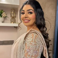 Modern glam with a touch of soft drama. This engagement or sangeet look is designed to be camera-ready and timeless, with beautiful soft curls and defined makeup.