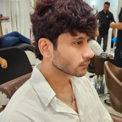 A profile view of this men's color and style. The shade is expertly blended, and the cut is tailored to complement his features perfectly.