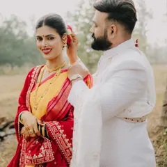 A candid moment during a traditional shoot, where the groom gently places a flower in his bride's hair. It’s these small, unscripted gestures of love that I aim to capture, showing the couple's bond amidst the beauty of their cultural attire.