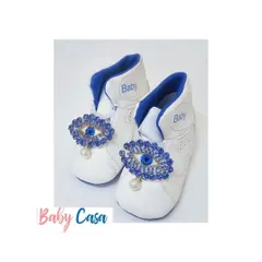 When a mom wants to protect her little dude from all evil eyes, she gets these custom shoes. These white baby booties feature a sparkling evil eye charm for style and protection.