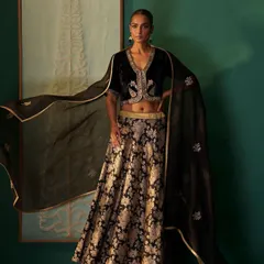 This look for a designer campaign pairs a gold zari brocade skirt with a hand-embroidered black velvet blouse. My styling, including the flowing organza dupatta, was intended to create a dramatic and luxurious black-and-gold ensemble.