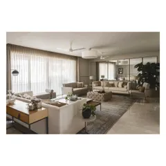 This wide shot shows the full living room layout, designed for easy conversation and flow. The neutral palette is calming, while the large plant adds a touch of nature.