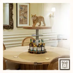 Here you can see the 'Bluff Boldly' table in action. The automated center rises to reveal a bar that holds up to 12 bottles and glasses, blending the function of a dining table with the excitement of a home bar.