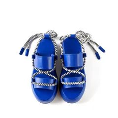 A clear, top-down e-commerce photograph of Jeetinder Sandhu's blue platform sandals on a pure white background. This angle provides a full view of the shoe's design, perfect for a primary product listing image.