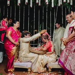 A beautiful ritual from a South Indian wedding, the 'jeerige bella', symbolizing the couple's union, surrounded by their loved ones.