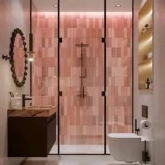 A bold and beautiful bathroom featuring pink subway tiles in the shower area, a dark wood vanity, and a unique decorative mirror.