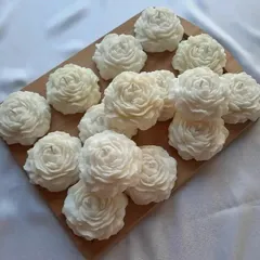 A batch of white peony candles ready for an order. Their classic color and beautiful shape make them a versatile gift and decor item.