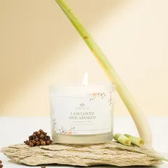 A lemongrass and clove scented candle styled with its raw ingredients. This natural, minimalist setup is perfect for brands that emphasize organic and natural products.