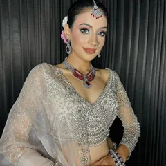 A stunning sagan bride. I created a look that was both traditional and modern, with a neat bun adorned with flowers, a small bindi, and makeup that highlighted her beautiful features.