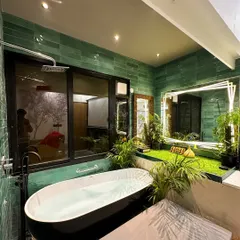 The ultimate in relaxation. I transformed this rooftop room into a private spa, featuring a standalone bathtub surrounded by lush greenery and mood lighting.