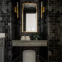 A vanity nook within the powder room, where the 'Fretwork' wallpaper provides a stunning, graphic backdrop. The design's sharp lines and dark tones create a chic and contemporary feel.