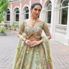 A Mehendi or Carnival event calls for a fun and vibrant look. I designed this playful style with creative eye makeup and a festive green lehenga, ensuring the bride stands out and feels amazing during her daytime celebrations.