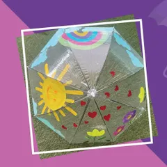 The final result of our umbrella painting activity. This colorful creation, full of sunshine and hearts, is ready to brighten up any rainy day. It's a perfect take-home gift.