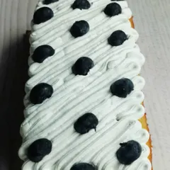 My Blueberry Tea Cake is a simple classic. The loaf is infused with fresh blueberries and topped with a light, airy whipped cream and more fresh berries.