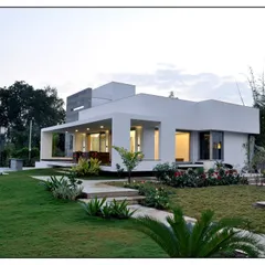 This landscape for a modern, minimalist home focuses on clean lines and a seamless flow between the indoor and outdoor areas. The design uses a mix of ornamental grasses and shrubs to soften the architecture.