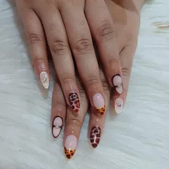Taking animal print to the next level with this detailed tortoiseshell design on almond-shaped nails. I added delicate rhinestones and a negative space cuff for a sophisticated finish.