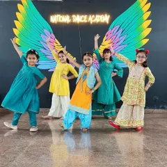 Our little dancers posing in their traditional outfits at the Greenfield studio. We love preparing them for performances, giving them a chance to showcase their talent and feel like stars.