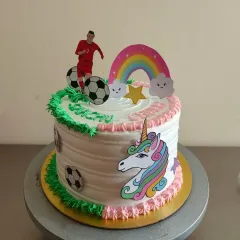 A fun cake for twins with different interests. One half is dedicated to unicorns and rainbows, while the other half is all about football.