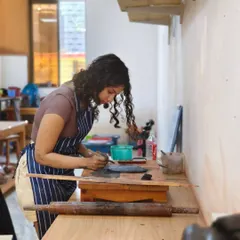An instructor is deeply focused on her work, demonstrating the dedication and passion that we bring to our craft and our teaching.