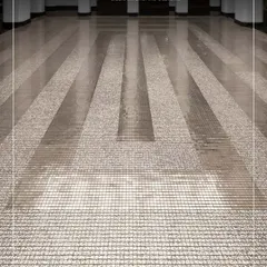 Platinum mosaics installed under a skylight at the Seema Gujral flagship store. The tiles create a delicate, concentric rhythm, playing with reflection and light to evoke a powerful emotion.