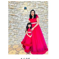 I designed these vibrant red gowns for a mother and daughter. The daughter's dress has a fun ruffled hem, perfect for twirling.
