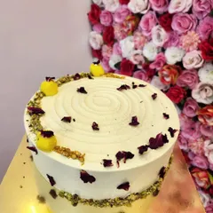 A fusion of two classic Indian sweets. My Rasmalai cake features a soft, moist sponge infused with rasmalai flavor, topped with delicate rose petals and pistachios. It's a unique dessert that's perfect for festive occasions.