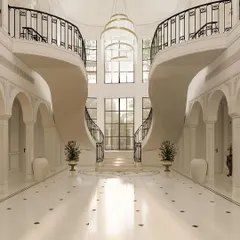 The arrival sets the tone for the entire hospitality experience. This neo-classical hotel lobby was designed around a magnificent double staircase, creating a breathtaking sense of scale and grandeur that defines ultra-luxury from the moment a guest steps inside.
