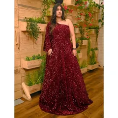 For a full glam look, this one-shoulder maroon sequin gown is a perfect choice. The all-over sparkle ensures you'll shine at any evening event.