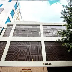 A wider view of the Vijaynagar renovation, showing the full extent of the new facade and how it creates a bold, contemporary statement in the neighborhood.
