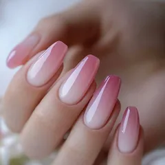 This is a perfect example of a pink and white ombre, also known as baby boomer nails. The seamless blend and high-gloss finish make it a popular choice for a sophisticated look.