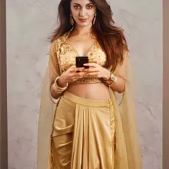 The stunning Kiara Advani in my golden Lydia Cape Set. This fusion wear piece combines a pre-draped dhoti skirt with an intricately embroidered blouse and a flowing organza cape, perfect for a modern wedding guest look.