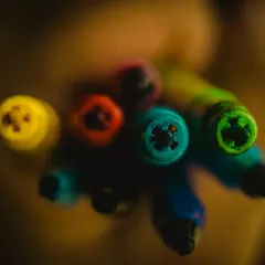 The tips of colored pens, shot with a very shallow depth of field. This technique transforms a simple subject into a beautiful abstract composition of color and light.